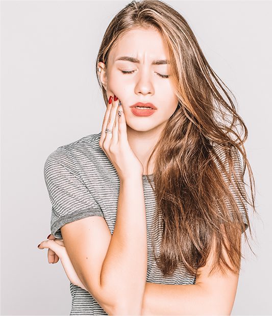 Woman holding her right jaw in pain.