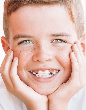 Child smiling and wearing a retainer